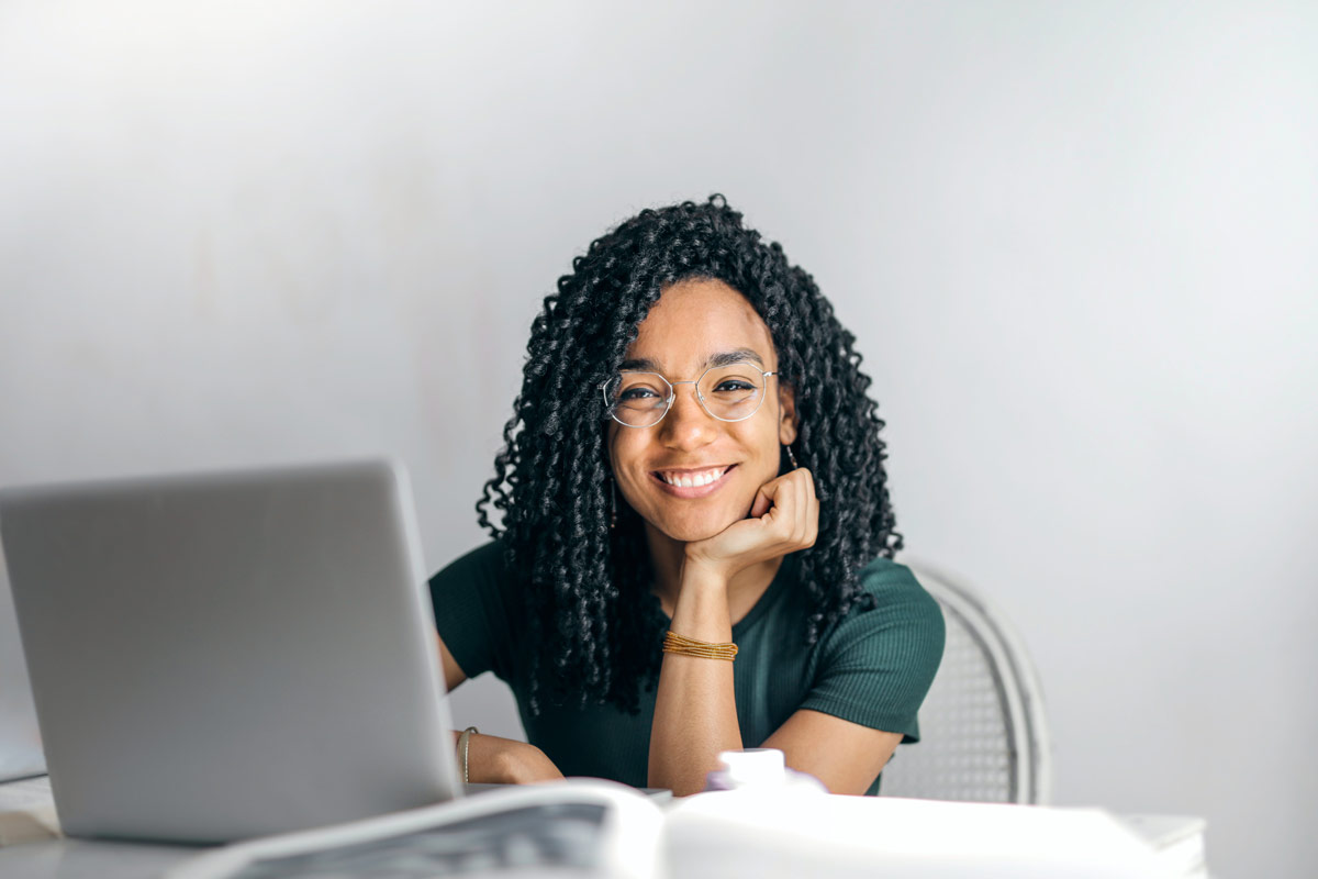 happy-ethnic-woman-sitting-at-table-with-laptop-3769021.jpg